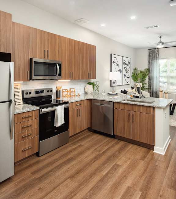 a kitchen with stainless steel appliances and wooden cabinets