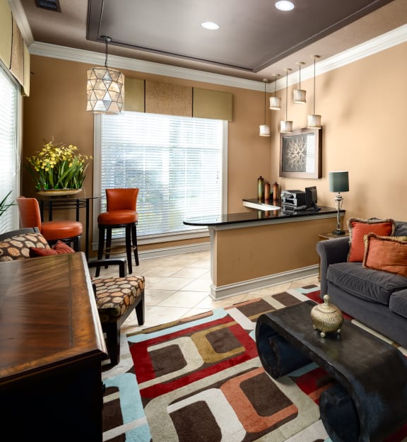 a living room with a couch and a kitchen