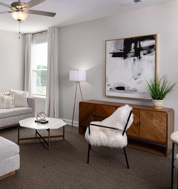 Living room with white sofa and ceiling fan at 1104 Residences homes for rent in Antioch, TN.	