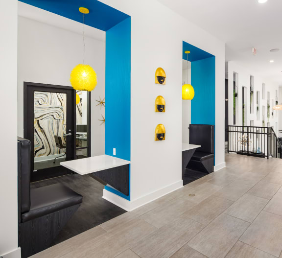 the lobby of a building with blue and white walls and yellow lights