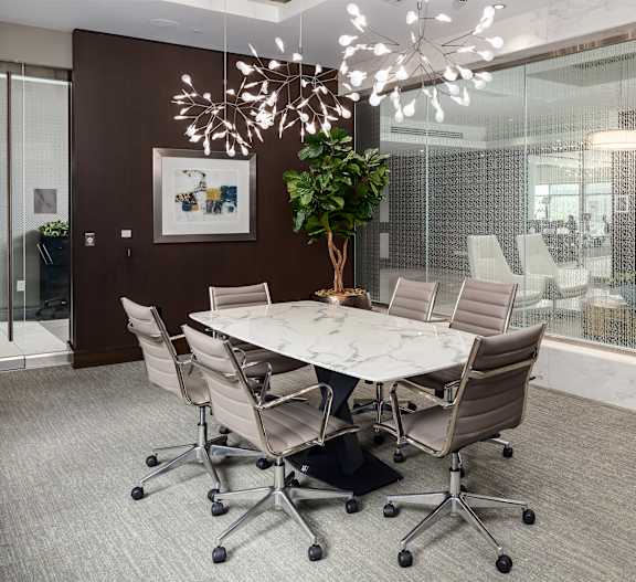 Elegant Conference Room at Tens on West Featuring Marble Table and Glass Walls