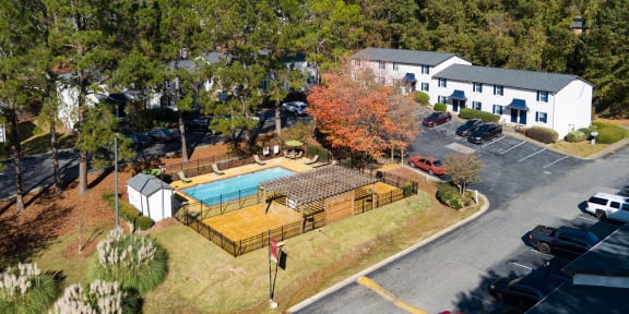 an aerial view of a backyard with a pool and a house