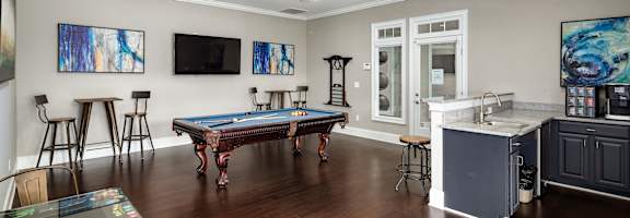 a game room with a pool table and a bar at Abberly Green Apartment Homes, Mooresville