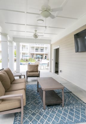 a living room with a couch and a coffee table and a television at The Station at River Crossing, Macon