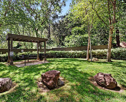 a backyard with a picnic area and rocks