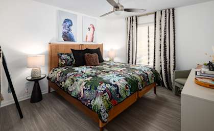 a bedroom with a bed and a ceiling fan