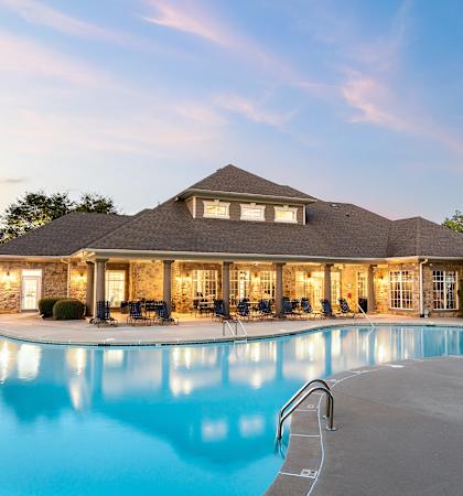 a swimming pool in front of a house