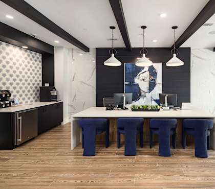 a dining room with a large table and blue chairs