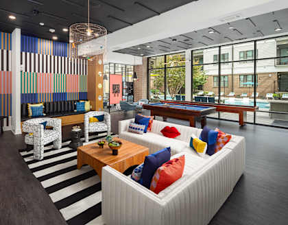 a lobby of a building with couches and a table