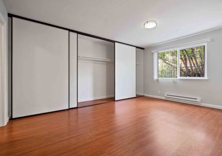 One-Bedroom Apartments In Santa Clara, CA - Hidden Lake - Spacious Bedroom With Hardwood Floors, Large Closet With Sliding Mirror Doors, And A Window For Natural Light