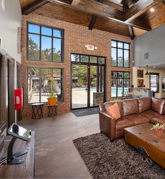a living room with a leather couch and a coffee table