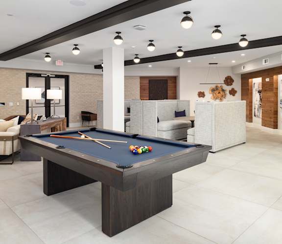 a clubhouse with a pool table in the middle of it
