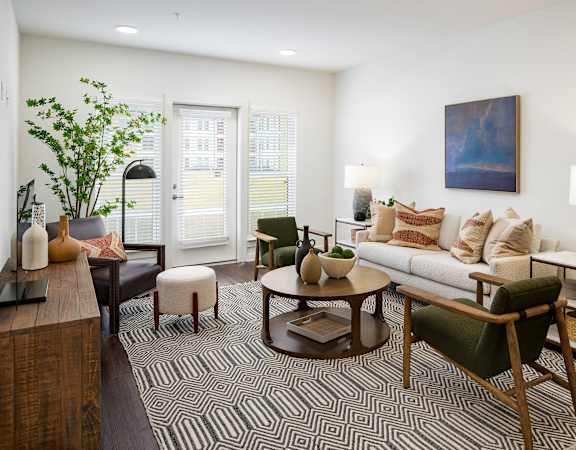 a living room with a couch and chairs and a rug