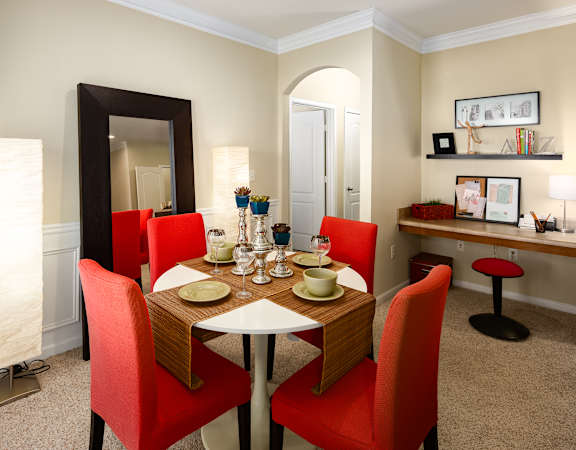 A dining room with a table set for two.