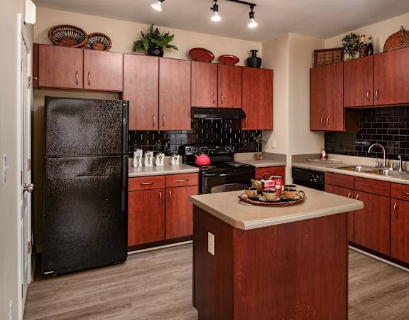 a kitchen with black appliances and wooden cabinets
