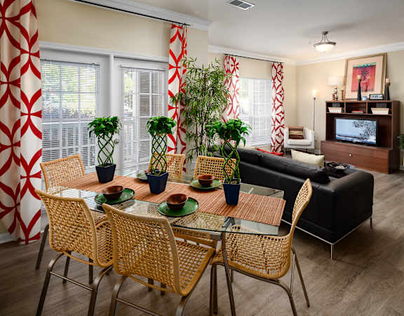 a living room and dining room with a table and chairs