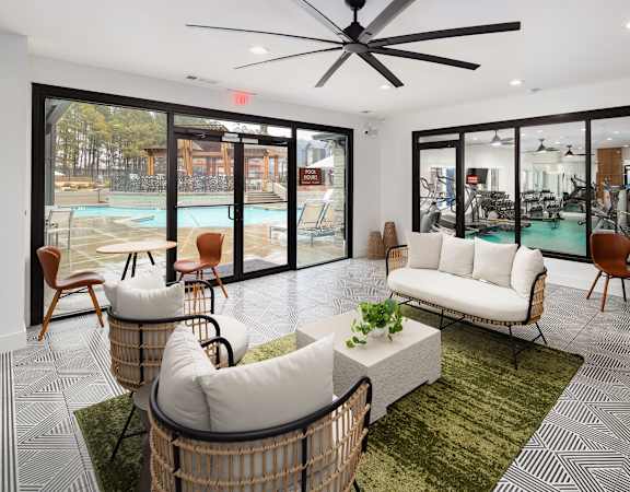 a living room with couches and chairs and a pool