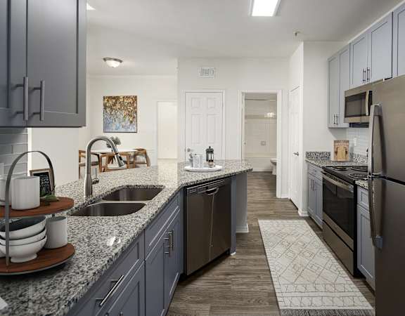 a kitchen with granite counter tops and stainless steel appliances