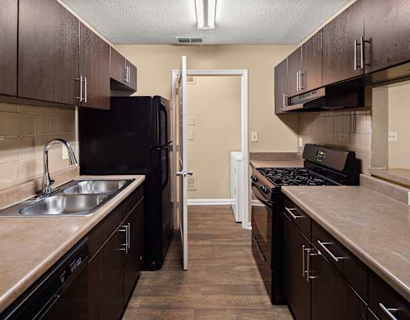a kitchen with a sink and a stove and a refrigerator