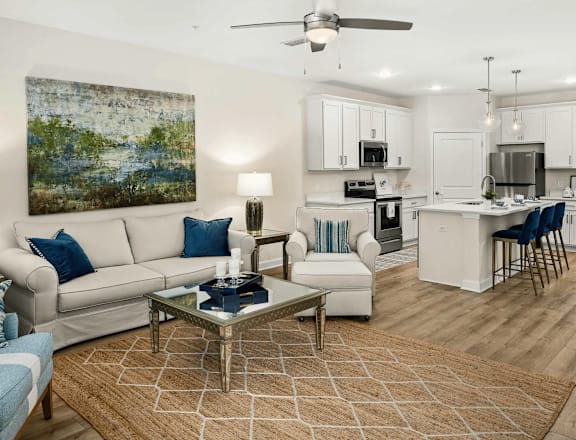 A living room with a white couch and a coffee table.