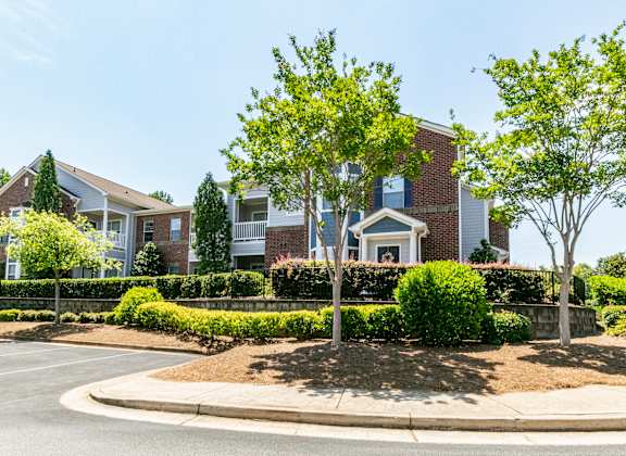 A row of houses with a well-maintained front yard.