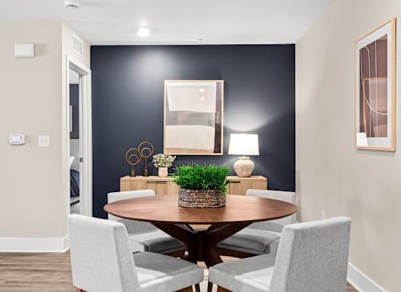 a dining room with a table and chairs