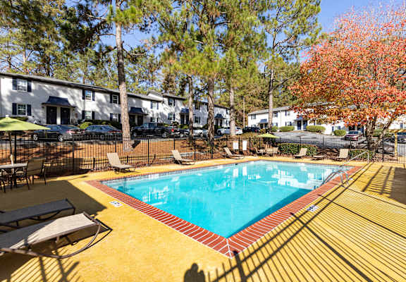 a resort style pool with chairs around it