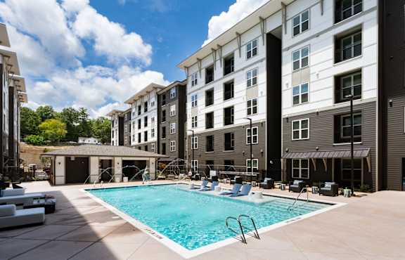 A swimming pool in front of apartment buildings.