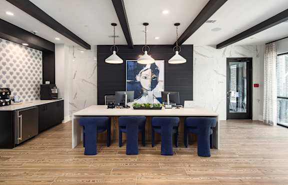 a dining room with a large table and blue chairs