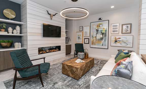 a living room with a fireplace and a tv on the wal at Emblem Alpharetta, Alpharetta, GA, 30009l