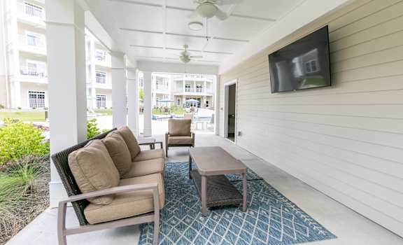 a living room with a couch and a coffee table and a television at The Station at River Crossing, Macon, GA