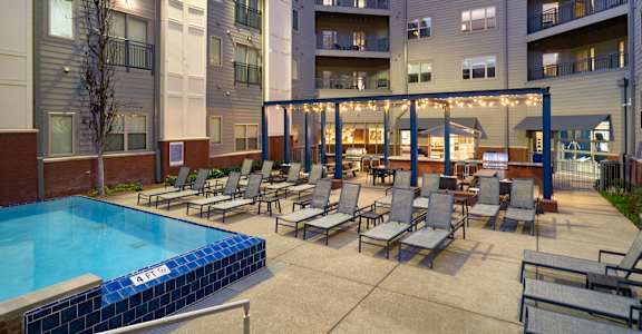 our apartments have a large pool and lounge area with chairs