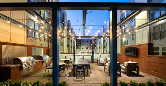 a patio with a table and chairs in a courtyard