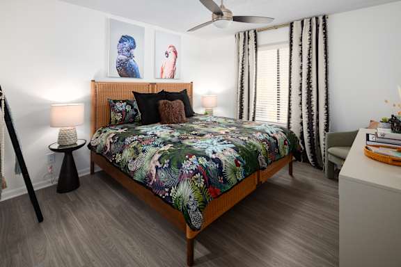 a bedroom with a bed and a ceiling fan