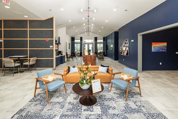 a lobby with a couch and chairs and a table