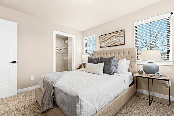 a bedroom with a large bed and a door to a closet