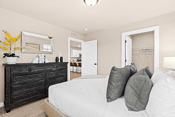 a bedroom with a large bed and a dresser
