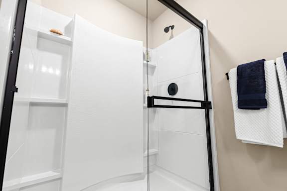 a small bathroom with a shower with a glass door