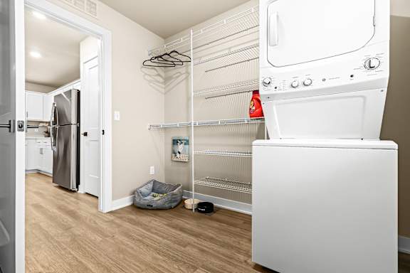 a laundry room with a washer and dryer and a refrigerator
