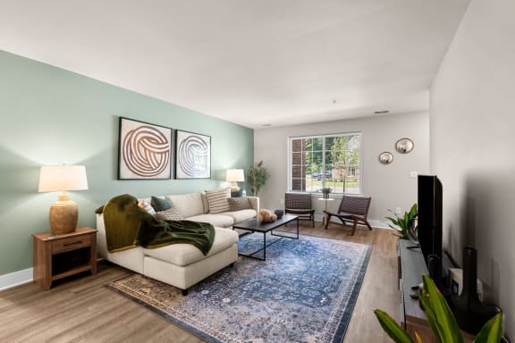 a living room with a couch and a table with a vase of flowers