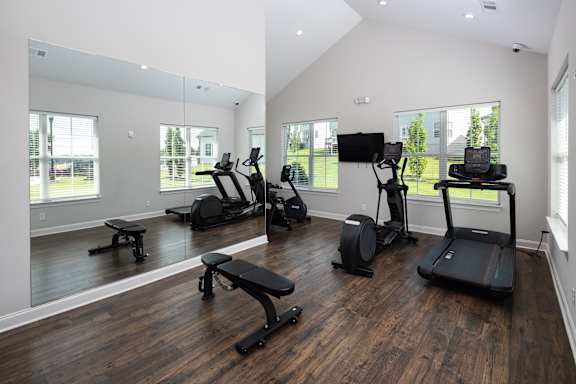 A spacious home gym with a variety of exercise equipment.