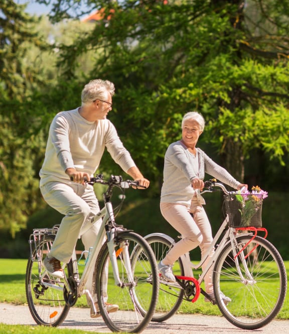 Little Canada, MN Montreal Courts |a man and a woman riding bikes in a park