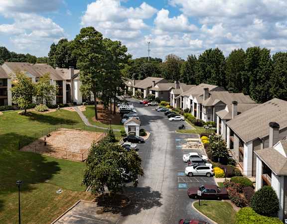an aerial view of a neighborhood with cars parked on a street