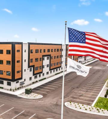 a rendering of a three story building with an american flag in front of it