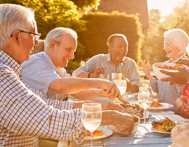a group of people sitting at a table eating food