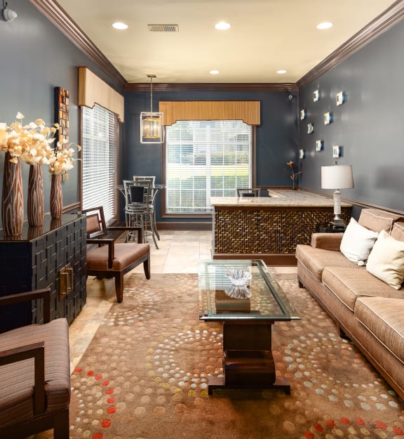a living room with blue walls and a brown couch