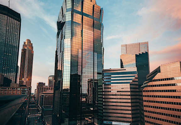 A cityscape with tall buildings and a clear sky.