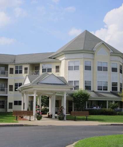 A large white building with a gazebo in front.