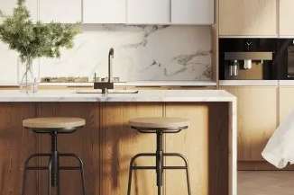 A kitchen with a marble backsplash and two stools.
