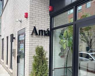 a sign on the side of a brick building with an arrow pointing down